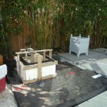 Construction of the firepit (framing) - 3.5" concrete thick walls - tinted, & smooth finish. Contemporary shape and material. Notice the Orangerie planter in the back