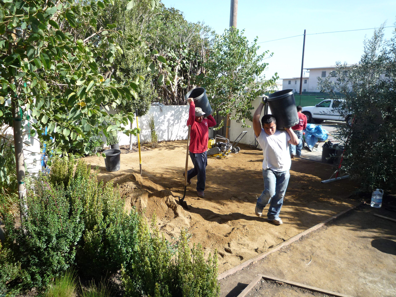 Laying down the decomposed granite in the frontyard. It will allow two park 2 cars. And it's environmentally correct.